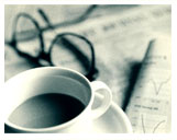 Image of Newspaper, coffee cup and eyeglasses